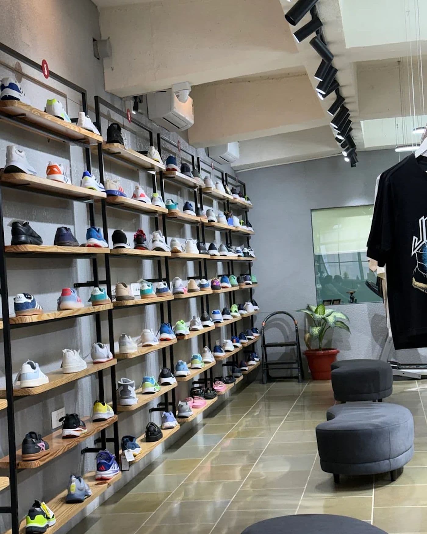 Footwear wall on wooden shelves at Originals By Shivaam